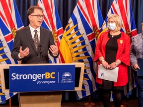 Health Minister Adrian Dix announces $30 million in funding for health services on northern Vancouver Island as Kathy McNeil, CEO for Island Health, middle, and Michelle Babchuk, MLA for North Island, look on at the B.C. legislature press theatre in Victoria on Friday, Jan. 27, 2023.