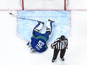Thatcher Demko #35 of the Vancouver Canucks lays injured on the ice during the first period of their NHL game against the Florida Panthers at Rogers Arena on December 1, 2022 in Vancouver, British Columbia, Canada. Florida won 5-1.