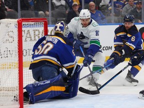 Dakota Joshua of the Vancouver Canucks shoots the puck against Jordan Binnington of the St. Louis Blues in the second period at Enterprise Center on February 23, 2023 in St Louis, Missouri.