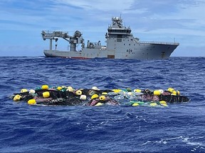 An undated handout photo received from the New Zealand Defence Force on Feb. 8, 2023 shows the Royal New Zealand Navy vessel HMNZS Manawanui retrieving 3.2 tonnes of cocaine adrift in the Pacific in an historic drugs bust estimated to be worth around $423 million.
