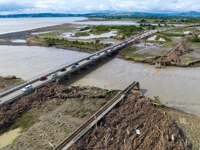 An aerial photo shows a rail bridge (R) damaged and washed away during Cyclone Gabrielle near Napier on February 16, 2023. (Photo by STR/AFP via Getty Images)