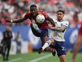 Real Salt Lake's Sergio Cordova, left, and Vancouver Whitecaps' Erik Godoy vie for the ball during the first half of an MLS soccer game in Vancouver last June.