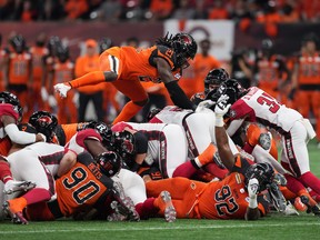 B.C. Lions' Jordan Williams (21) leaps on top of the pile as Ottawa Redblacks quarterback Caleb Evans, centre right, pushes ahead for a first down during the first half of CFL football game in Vancouver last season. 
The Lions traded Williams to the Toronto Argonauts on Thursday.