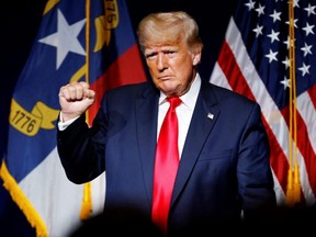 Former U.S. President Donald Trump makes a fist while reacting to applause after speaking at the North Carolina GOP convention dinner in Greenville, N.C., June 5, 2021.