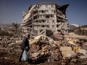 A man walks past a destroyed building on Feb. 13, 2023 in Nurdagi, Turkey.