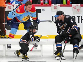 Florida Panthers left wing Matthew Tkachuk (19) watches as Washington Capitals left wing Alex Ovechkin (8) talks with his son Sergei Ovechkin during the 2023 NHL All-Star Skills Competition at FLA Live Arena.