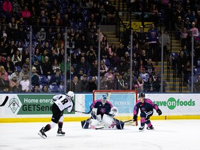 Ty Thorpe of the Vancouver Giants gets a shot off on Victoria Royals goalie Braden Holt in Vancouver's 2-1 overtime win on Friday in Victoria.