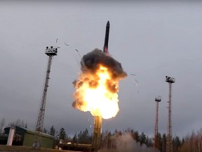 In this photo taken from undated footage distributed by Russian Defense Ministry Press Service, an intercontinental ballistic missile lifts off from a truck-mounted launcher somewhere in Russia.