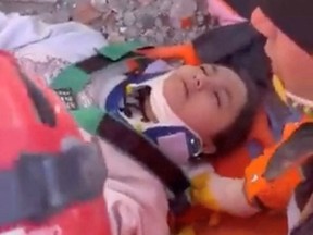 A teenage girl is pulled alive from the rubble by emergency services more than 10 days after an earthquake that has killed more than 42,000 people in the country and neighbouring Syria, in Kahramanmaras province, Turkey, Feb. 16,2023, in this still image taken from a video posted on social media.