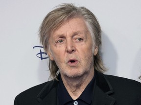 Paul McCartney poses for photographers upon arrival for the premiere of the film 'If These Walls Could Sing' in London, Monday, Dec. 12, 2022.