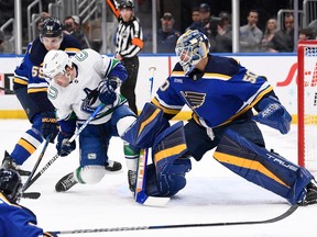 Vancouver Canucks right wing Conor Garland is called for goaltender interference against St. Louis Blues goaltender Jordan Binnington during the first period of an NHL hockey game Thursday, Feb. 23, 2023, in St. Louis.