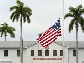 In this photo reviewed by U.S. military officials, a flag flies at half-staff in honour of the U.S. service members and other victims killed in the terrorist attack in Kabul, Afghanistan, at Marine Corps Security Force Company, Aug. 27, 2021, in Guantanamo Bay Naval Base, Cuba.