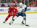 Vancouver Canucks right wing Brock Boeser brings the puck up ice as as Detroit Red Wings center Joe Veleno defends during the first period at Little Caesars Arena. Tim Fuller-USA TODAY Sports