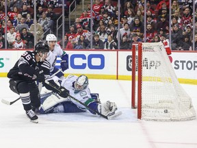 New Jersey Devils centre Jack Hughes (86) scores a goal past Vancouver Canucks goaltender Collin Delia (60) during the first period at Prudential Center.