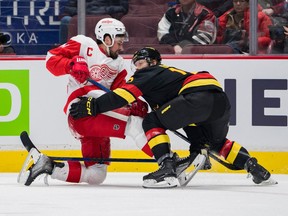Detroit Red Wings' Dylan Larkin (71) battles with Vancouver Canucks' Sheldon Dries (15) in the second half at Rogers Arena.
