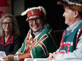 Chief John Powell (centre) of the Mamalilikulla First Nation sits with Joyce Murray, Minister of Fisheries, Oceans and the Canadian Coast Guard (back left), and former chief Richard Sumner during the announcement about a new marine refuge in the Gwaxdlala/Nalaxdlala (Lull Bay/Hoeya Sound) area in Knight Inlet on B.C.'s central coast, at the International Marine Protected Areas Congress (IMPAC5) in Vancouver, on Feb. 5, 2023.