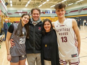 Andrew and Cheryl Lloyd, flanked by their kids Izzy (left) and Aidan (right), standing courtside — a typical place for all of them — earlier this month in Port Moody.