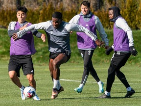 Vancouver Whitecaps FC's Sergio Cordova, middle, fights through the defence during the team's practice in Vancouver on Tuesday, Feb. 21, 2023. Cordova is a Venezuelan international acquired from German Bundesliga side FC Augsburg.