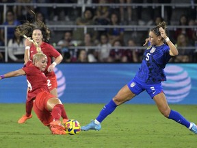 U.S. forward Trinity Rodman (5) and Canada forward Adriana Leon compete for the ball during the first half of a SheBelieves Cup soccer match Thursday, Feb. 16, 2023, in Orlando, Fla.