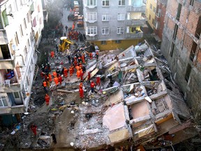 Search-and-rescue workers gather around a collapsed building in Istanbul, Turkey, in 2007. Relying on international SAR teams for the critical hours of search and rescue is not very realistic, says Ali Asgary.