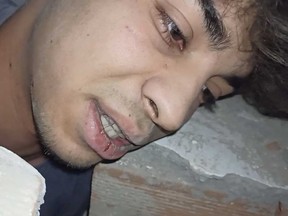 In this screenshot taken from video, Taha Erdem, 17, records himself using his smartphone as he is trapped under the rubble of a collapsed building after the Feb. 6 earthquake in Adiyaman, Turkey, Monday, Feb. 6, 2023.