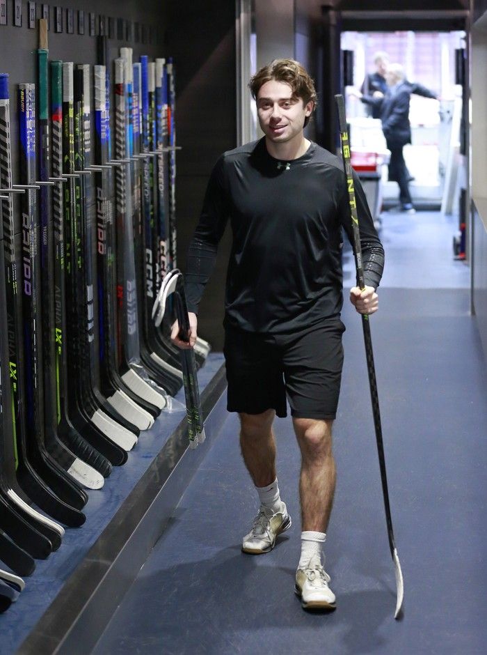 Quinn Hughes of the Vancouver Canucks walks with his game sticks before their NHL game against the Los Angeles Kings at Rogers Arena on Nov. 18, 2022.