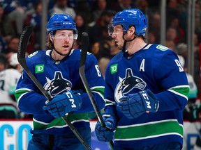 Brock Boeser of the Vancouver Canucks talks to teammate J.T. Miller during a NHL game at Rogers Arena in Vancouver. Photo: Jeff Vinnick/NHLI via Getty Images