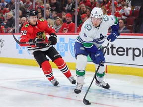 Brock Boeser controls the puck against Nikita Zaitsev of the Blackhawks at the United Center on March 26 in Chicago.