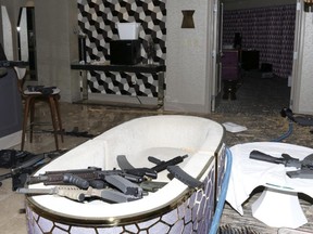 This Oct. 2017 file photo released by the Las Vegas Metropolitan Police Department Force Investigation Team Report shows a number of guns in the interior of mass shooter Stephen Paddock's 32nd floor room of the Mandalay Bay hotel in Las Vegas. Paddock a high-roller gambler who opened fire in 2017 on concertgoers in Las Vegas had lost tens of thousands of dollars while gambling weeks before the mass shooting and was upset with the way the casinos had been treating him, according to FBI documents made public this week.