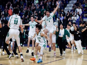 St. Patrick celebrates winning the Triple A boys basketball provincial title for a second straight season on Saturday.