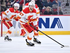 Radim Zohorna of the Calgary Flames skates the puck during the third period against the Montreal Canadiens at Centre Bell on December 12, 2022 in Montreal, Quebec, Canada.