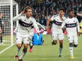 Vancouver Whitecaps FC forward Simon Becher  celebrates his last minute tying goal against Minnesota United FC with teammates during the second half at Allianz Field in St. Paul, Minn March 25, 2023.