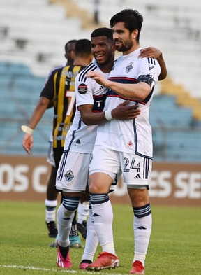 Vancouver Whitecaps striker Brian White (right) celebrates with teammate Ali Admed after scoring against Real CD Espana during the second leg of their CONCACAF Champions League series at the Olimpico Metropolitano stadium in San Pedro Sula, Honduras, on Saturday.