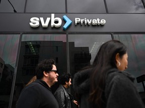 The SVB Private logo is displayed outside of a Silicon Valley Bank branch in Santa Monica, California. Some economists are predicting that the measures taken to mitigate the fallout from the Silicon Valley and Signature Bank collapse may actually force fixed mortgage rates down a bit.