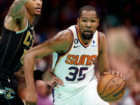 Phoenix Suns forward Kevin Durant (35) drives to the basket past Charlotte Hornets guard Kelly Oubre Jr. (12) during the second half at Spectrum Center.