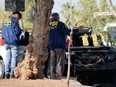 Investigations police inspect vehicles burnt by individuals near the Arturo Merino Benitez International Airport in Santiago after the attempted robbery of from an armoured van.