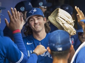 Toronto Blue Jays starting pitcher Kevin Gausman met by teammates in the dugout after throwing an inning of action against the Tampa Bay Rays in their spring training game in Dunedin, Florida on Friday, March 3, 2023.