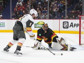 Vegas Golden Knights' Phil Kessel, left, scores against Vancouver Canucks goalie Thatcher Demko during the first period at Rogers Arena on Tuesday, March 21, 2023.