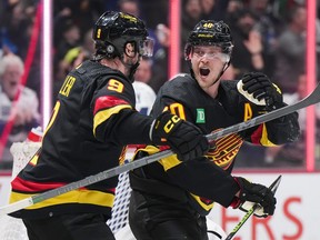 Vancouver Canucks' Elias Pettersson, right, celebrates his shorthanded goal against the Toronto Maple Leafs with teammate J.T. Miller during the third period of an NHL hockey game in Vancouver, on Saturday, March 4, 2023.