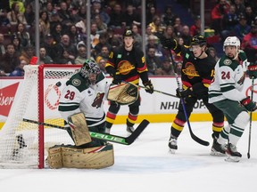Minnesota Wild goalie Marc-Andre Fleury allows a goal to Vancouver Canucks’ Brock Boeser, not seen, as Vitali Kravtsov, back centre, Sheldon Dries and Minnesota’s Matt Dumba watch during the first period of an NHL hockey game in Vancouver, on Thursday, March 2, 2023.