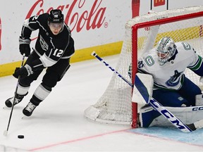 Los Angeles Kings left wing Trevor Moore (12) controls the puck next to Vancouver Canucks goaltender Thatcher Demko (35) in an NHL game at Crypto.com Arena. Photo: Richard Mackson-USA Today Sports