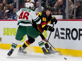 Minnesota Wild defenceman Jared Spurgeon checks Vancouver Canucks forward Andrei Kuzmenko in the first period at Rogers Arena March 2, 2023.