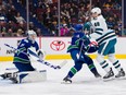 Vancouver Canucks goalie Thatcher Demko  makes a save as defenceman Kyle Burroughs battles with San Jose Sharks forward Tomas Hertl  in the second period at Rogers Arena March 23, 2023.