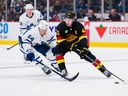 Toronto Maple Leafs forward David Kampf defends against Vancouver Canucks defenceman Quinn Hughes at Rogers Arena on March 4.