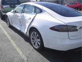 After a sideswiping accident, this 2014 Tesla S sports sedan had to be written off due to the high costs of replacing damaged parts.