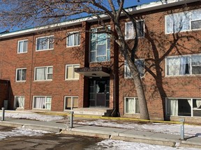 The glass in an entrance door to an apartment is smashed near 132 Street and 114 Ave on Thursday, March 16, 2023. Two EPS members were killed in the line of duty after responding to a domestic call in the area.