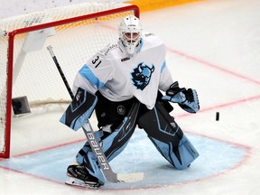 Dinamo Minsk goaltender Nikita Tolopilo defends the net during the 2020/2021 Kontinental Hockey League season. Tolopilo spent the next two seasons in the Swedish second division with Sodertalje SK.