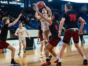 Terry Fox Ravens Parker Kennedy takes a shot while playing against the West Vancouver Highlanders during the BC Boys Basketball Provincial Championships at the Langley Events Centre  March 7, 2023. Terry Fox moved on after beating the No. 9 West Vancouver Highlanders 70-45.