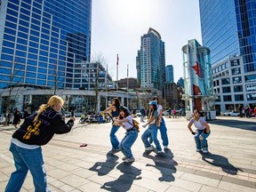 Young woman dance outside Canada Place, Vancouver's cruise ship terminal, on Saturday, March 18, 2023.