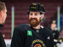 Defenceman Filip Hronek flashes a smile during practice with his new teammates on Tuesday. ‘He’s itching to go,’ coach Rick Tocchet said of his new blueliner.